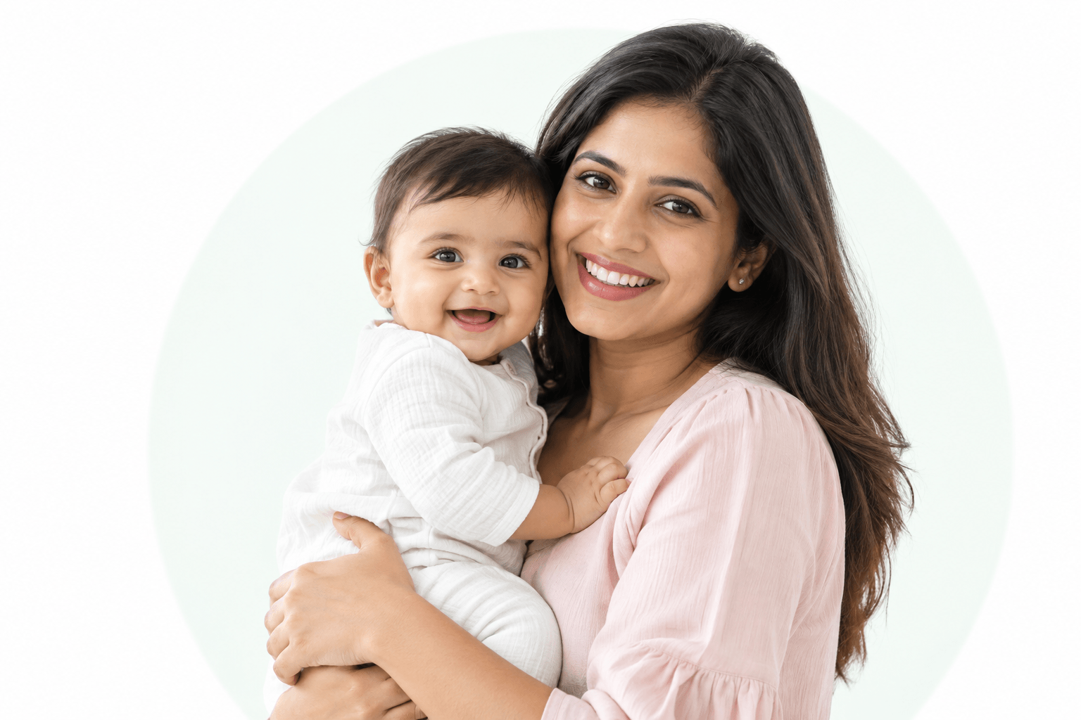 A smiling mother holding her young child
